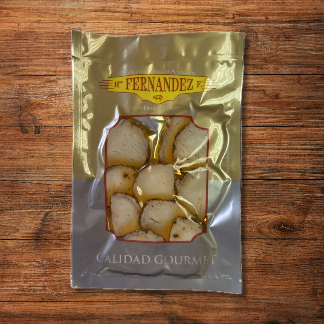 Lomo de orza loncheado, embutido artesanal adobado en especias y aceite de oliva sobre tabla rústica